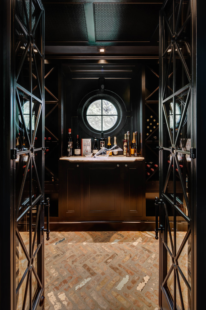 Design ideas for a traditional wine cellar in Houston with brick floors and display racks.