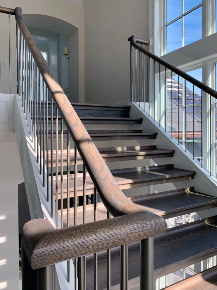 Diseño de escalera suspendida contemporánea con escalones de madera y barandilla de madera