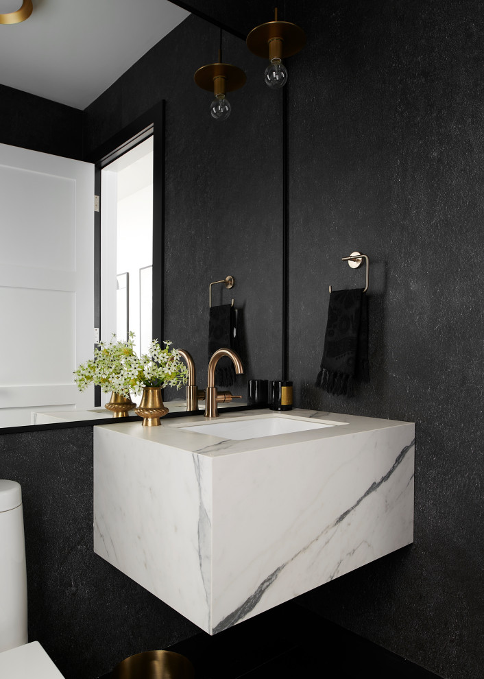 Photo of a mid-sized contemporary powder room in Toronto with white cabinets, black walls, porcelain floors, an undermount sink, engineered quartz benchtops, black floor, white benchtops, a floating vanity and wallpaper.