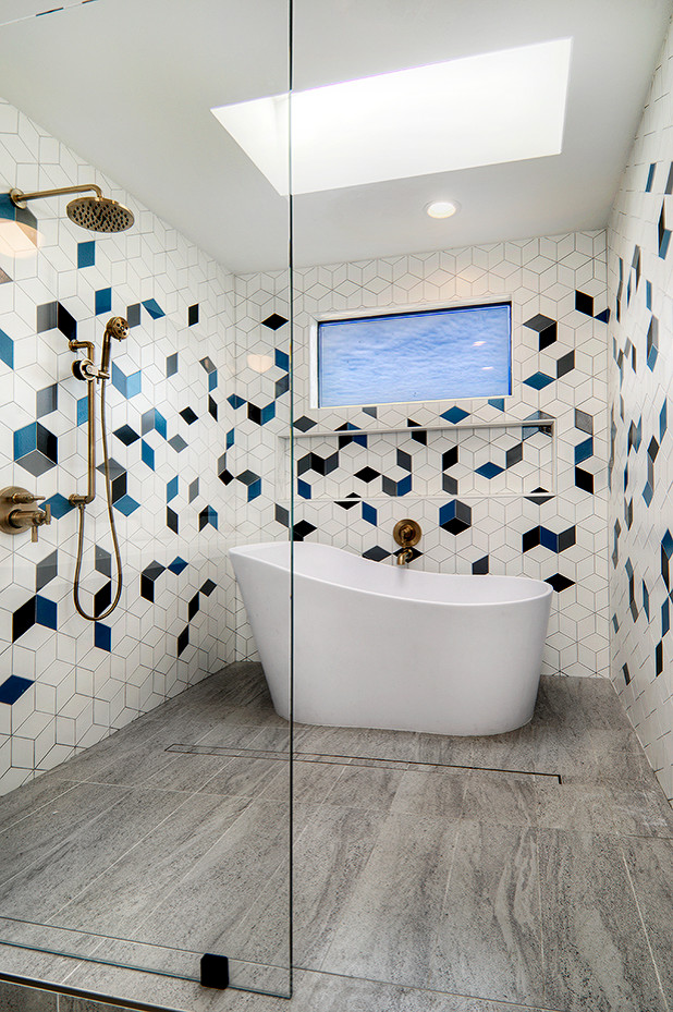 Photo of a mid-sized midcentury master wet room bathroom in San Francisco with flat-panel cabinets, medium wood cabinets, a freestanding tub, a one-piece toilet, multi-coloured tile, ceramic tile, white walls, ceramic floors, an undermount sink, engineered quartz benchtops, grey floor, an open shower and white benchtops.