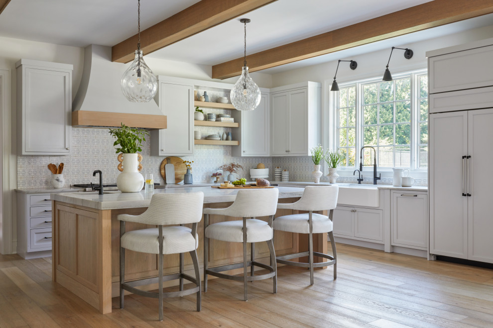 Kitchen - large transitional medium tone wood floor, brown floor and exposed beam kitchen idea in New York with a farmhouse sink, paneled appliances and an island