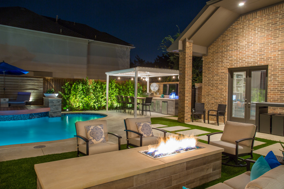 Photo of a mid-sized modern backyard patio in Dallas with an outdoor kitchen, decking and an awning.