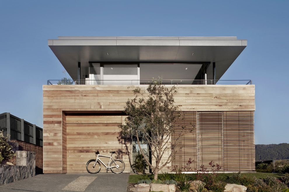 Inspiration for a contemporary two-storey brown exterior in Sydney with wood siding.