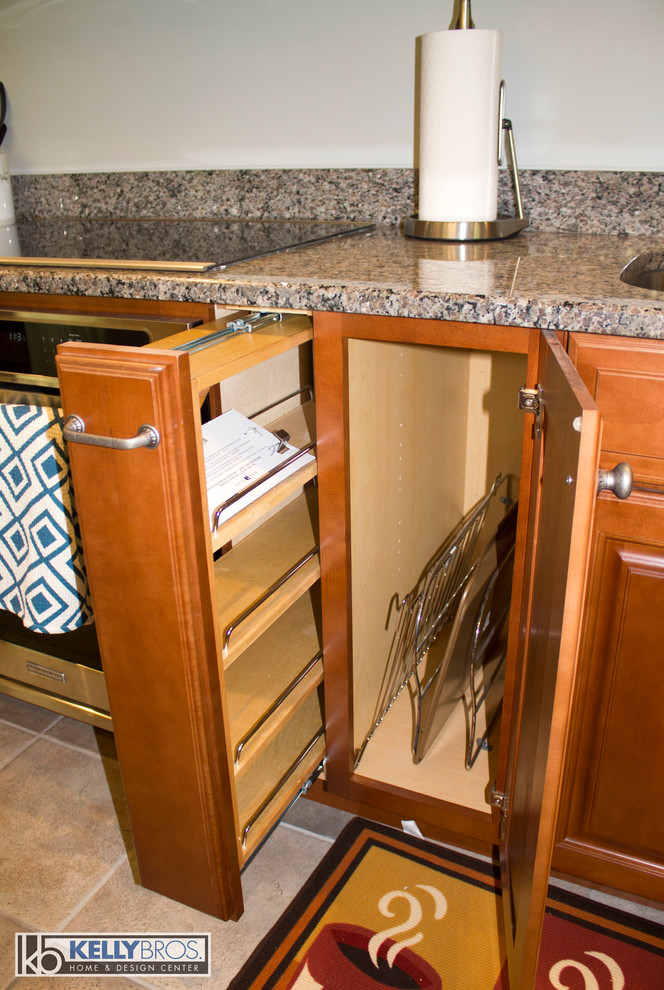 Home design - large transitional u-shaped ceramic tile home design idea in Cincinnati with a double-bowl sink, raised-panel cabinets, medium tone wood cabinets, granite countertops, stainless steel appliances and an island