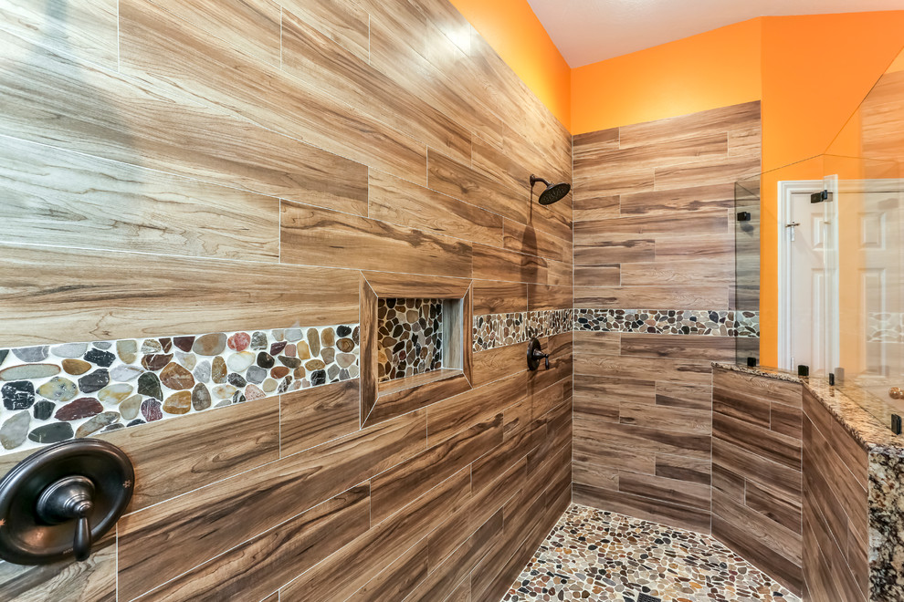 Design ideas for a large master bathroom in Houston with beaded inset cabinets, green cabinets, a double shower, a two-piece toilet, brown tile, porcelain tile, orange walls, porcelain floors, an undermount sink and granite benchtops.