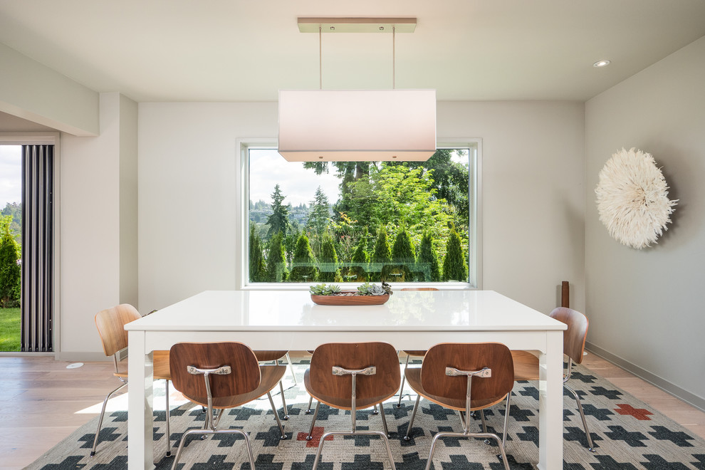Inspiration for a contemporary dining room in Seattle with beige walls and light hardwood floors.