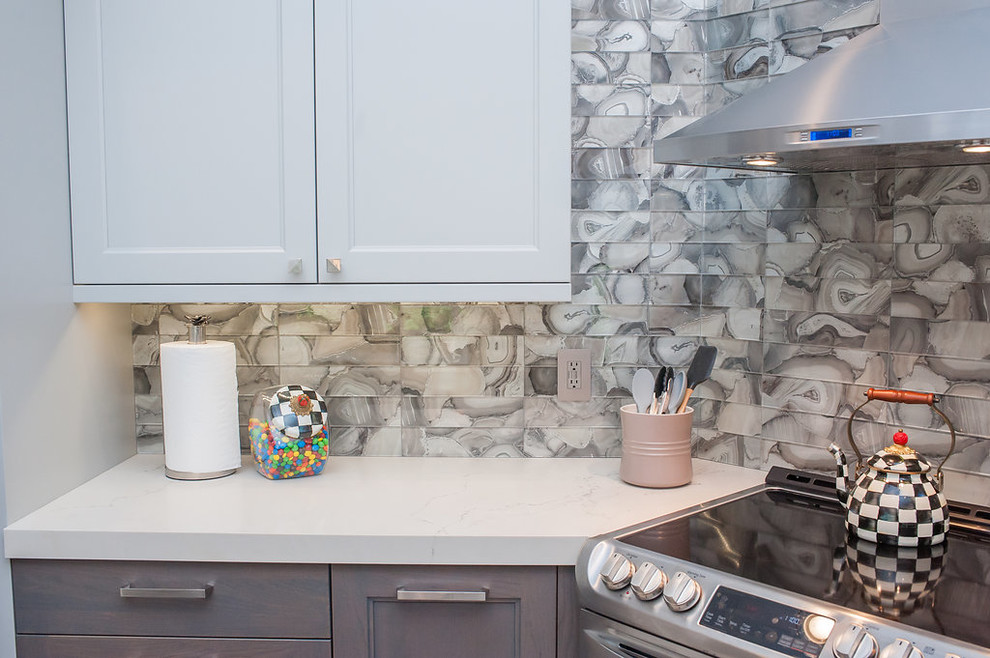 Mid-sized transitional u-shaped porcelain tile and beige floor eat-in kitchen photo in Miami with an undermount sink, shaker cabinets, gray cabinets, quartz countertops, gray backsplash, glass tile backsplash, stainless steel appliances, an island and white countertops