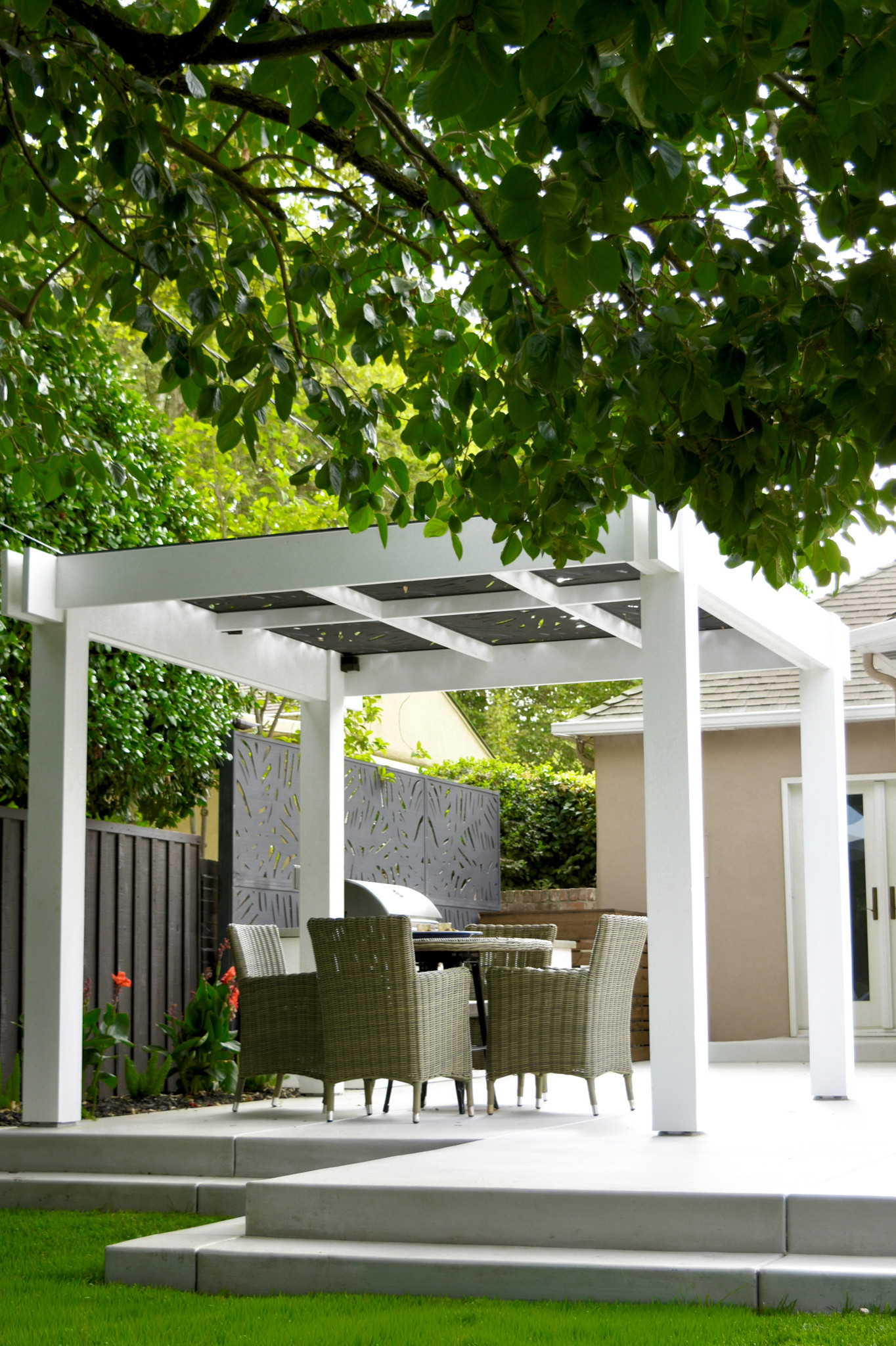 Daytime View of Pergola, Dining Area, and Outdoor Kitchen Privacy Screen