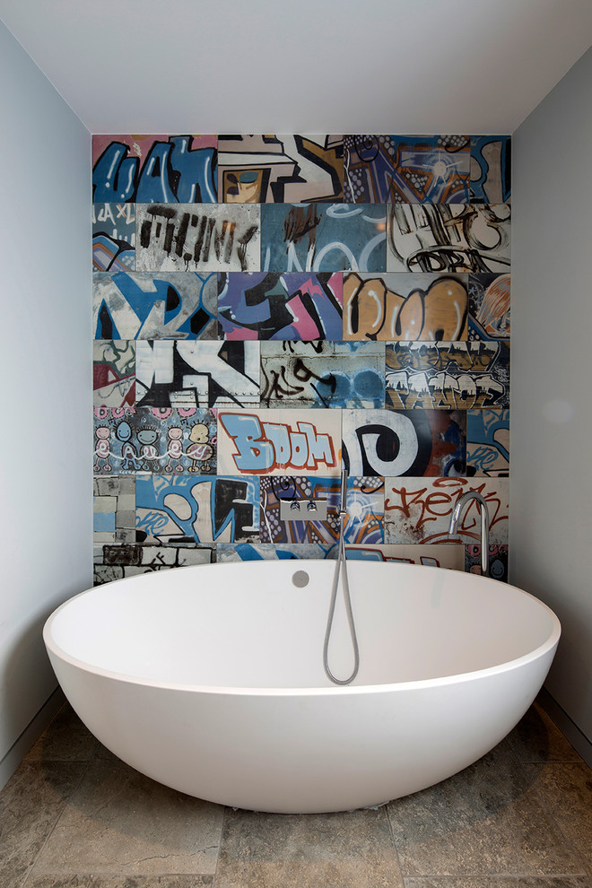 This is an example of a small contemporary bathroom in London with a freestanding tub, multi-coloured walls and multi-coloured tile.