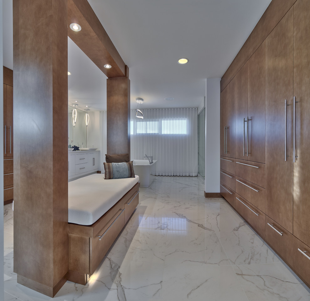 Large contemporary dressing room in Other with flat-panel cabinets, medium wood cabinets and porcelain floors.