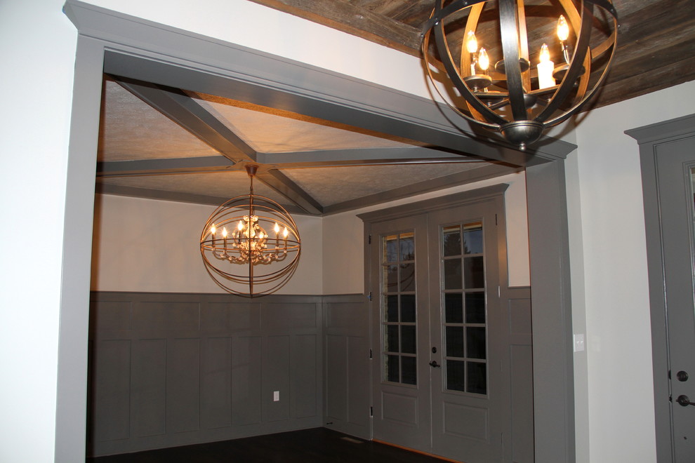 Inspiration for a mid-sized rustic dark wood floor and brown floor foyer remodel with white walls and a gray front door