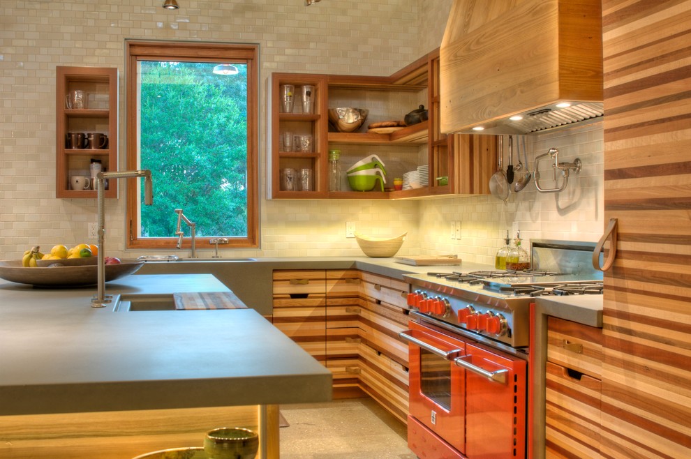 Mid-sized country l-shaped open plan kitchen in Other with an integrated sink, open cabinets, medium wood cabinets, concrete benchtops, coloured appliances, white splashback, ceramic splashback, concrete floors, with island, grey floor, grey benchtop and exposed beam.