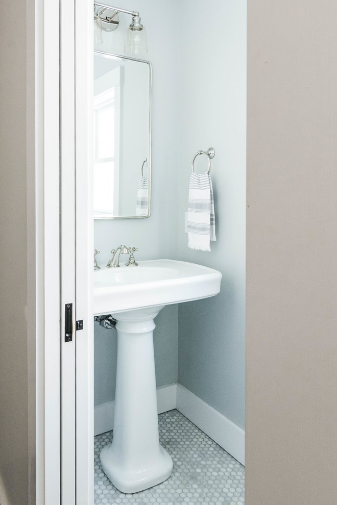 Photo of a small country powder room in Portland Maine with grey walls, marble floors, a pedestal sink and grey floor.