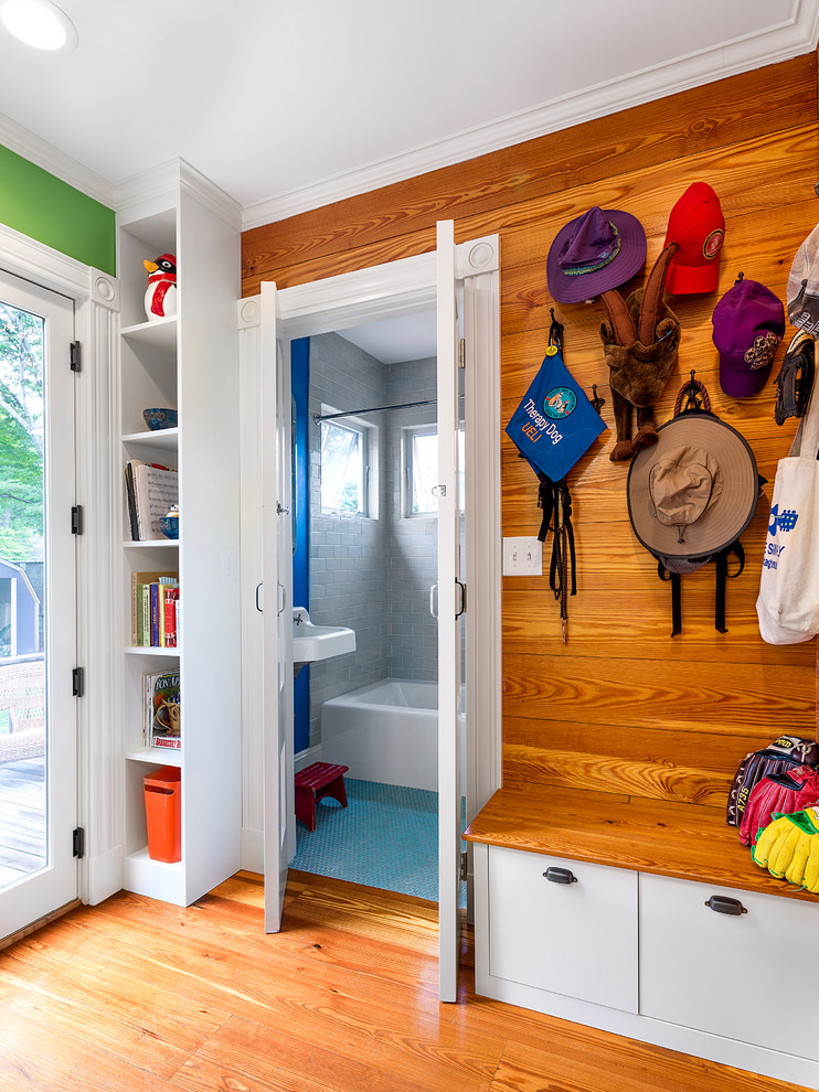 Photo of a small eclectic mudroom in Boston with multi-coloured walls, light hardwood floors and a single front door.