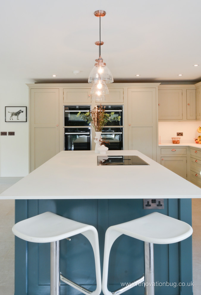 Large modern kitchen/diner in Surrey with an integrated sink, shaker cabinets, grey cabinets, an island and white floors.