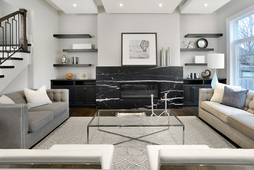 Inspiration for an expansive transitional open concept family room in Toronto with grey walls, dark hardwood floors, a standard fireplace, a stone fireplace surround, a wall-mounted tv and brown floor.