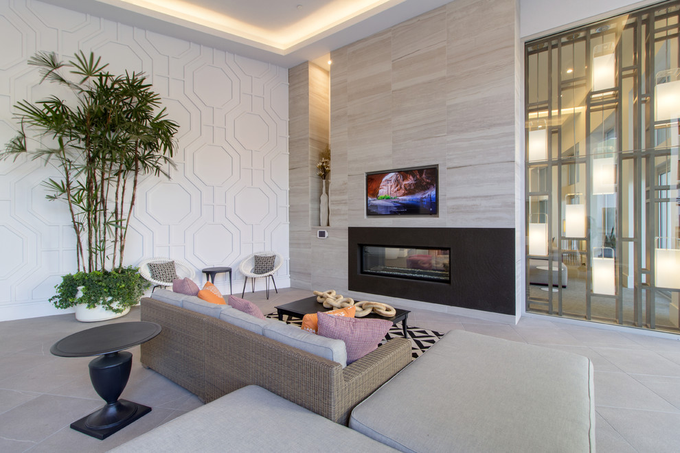 Contemporary open concept family room in Orange County with white walls, a ribbon fireplace, a metal fireplace surround, a wall-mounted tv and beige floor.