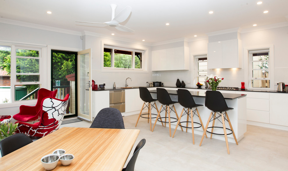 Inspiration for a mid-sized contemporary galley eat-in kitchen in Sydney with a double-bowl sink, white cabinets, quartz benchtops, white splashback, ceramic splashback, stainless steel appliances, ceramic floors and with island.