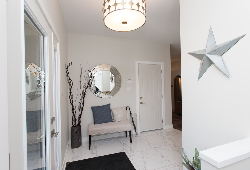 Example of a small transitional marble floor and white floor front door design with beige walls and a white front door