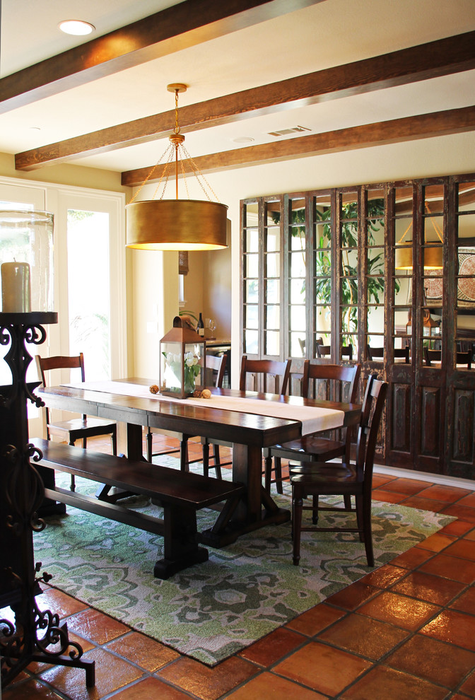 Photo of a mid-sized kitchen/dining combo in San Luis Obispo with beige walls, terra-cotta floors and orange floor.