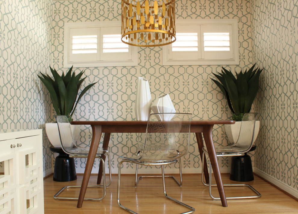 Design ideas for a midcentury dining room in Orange County with medium hardwood floors.