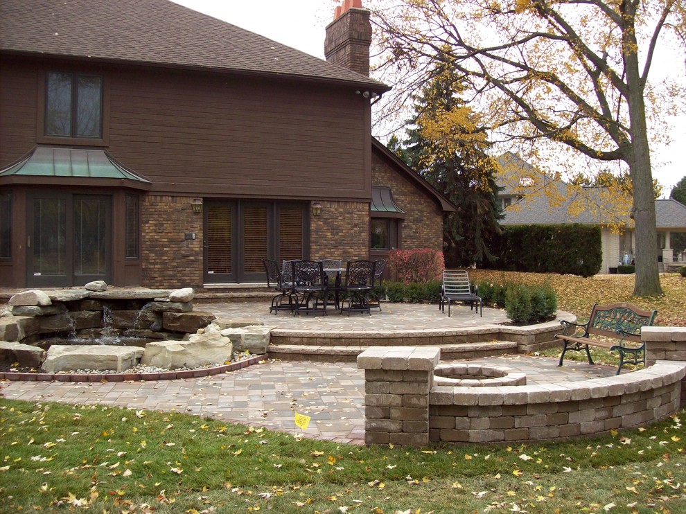 This is an example of a traditional patio in Detroit with brick pavers.
