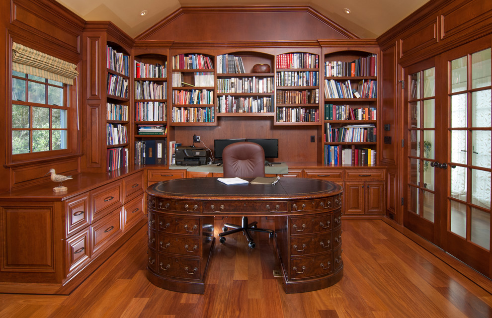 This is an example of a traditional home office in San Francisco with dark hardwood floors and a freestanding desk.