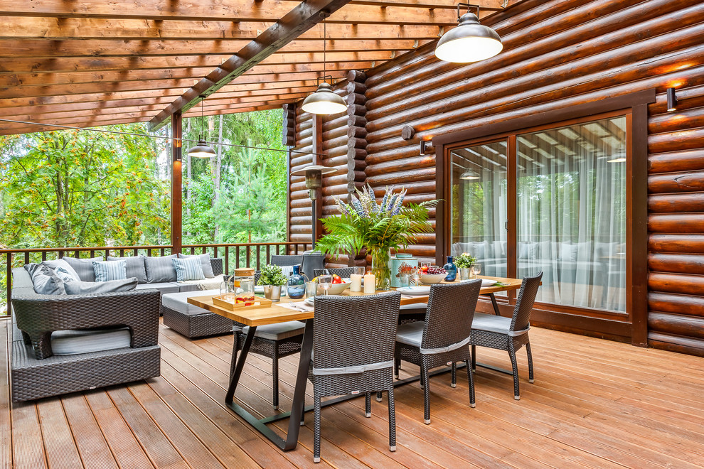 Large country side yard deck in Moscow with a pergola.