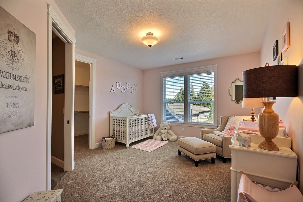 Inspiration for a large transitional guest bedroom in Portland with beige walls and carpet.