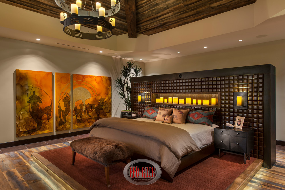 Expansive modern master bedroom in Phoenix with beige walls and medium hardwood floors.