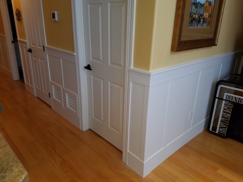 Design ideas for a mid-sized traditional hallway in Other with yellow walls, medium hardwood floors and brown floor.