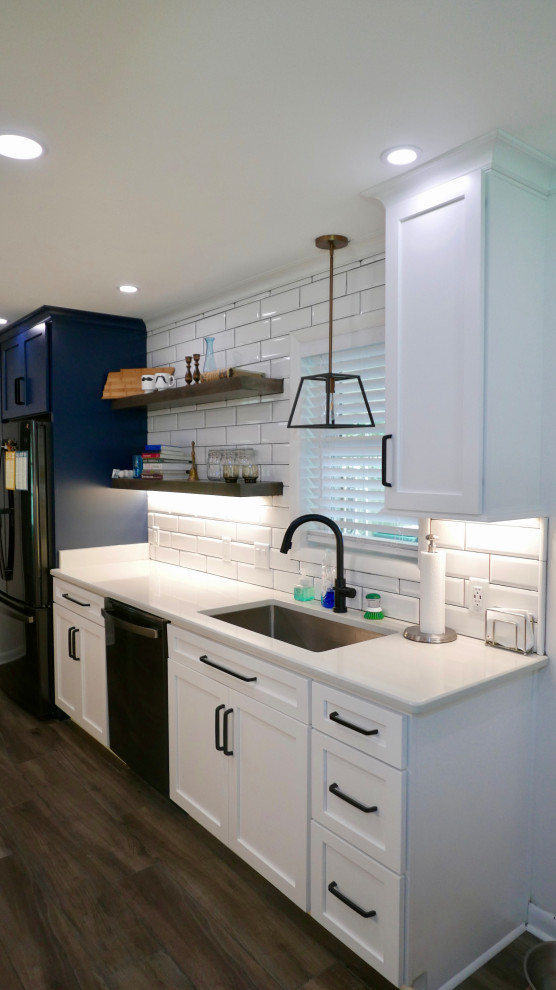 Mid-sized transitional galley porcelain tile and gray floor eat-in kitchen photo with an undermount sink, shaker cabinets, white cabinets, quartz countertops, white backsplash, subway tile backsplash, black appliances, no island and white countertops