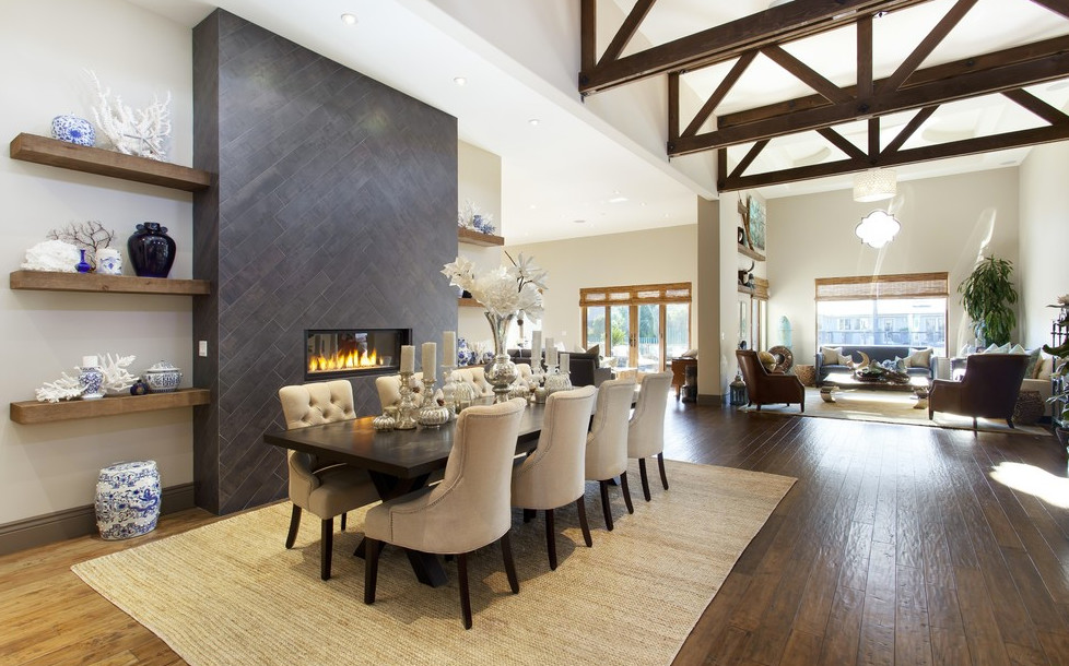 This is an example of a large traditional open plan dining in Los Angeles with beige walls, dark hardwood floors, a ribbon fireplace and a tile fireplace surround.