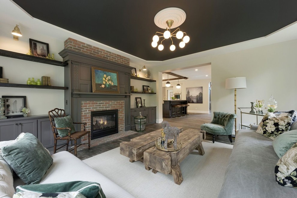 Photo of a large traditional formal open concept living room in Minneapolis with grey walls, dark hardwood floors, a standard fireplace, a brick fireplace surround, no tv and brown floor.
