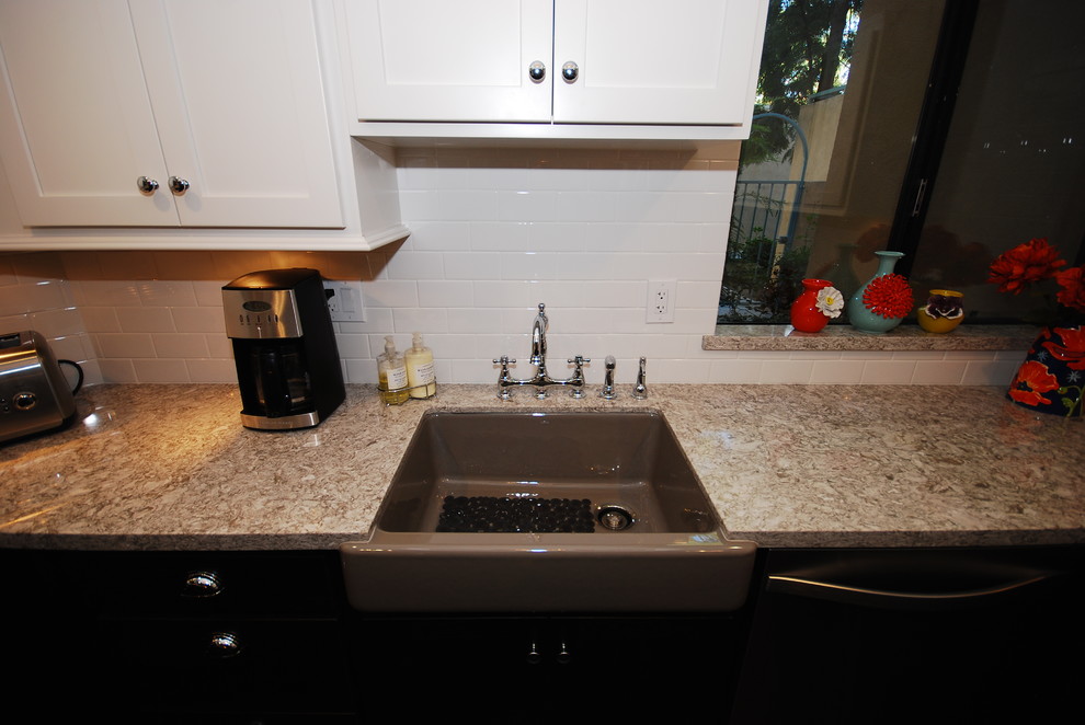Eat-in kitchen - small transitional u-shaped porcelain tile eat-in kitchen idea with a farmhouse sink, shaker cabinets, white cabinets, quartz countertops, white backsplash, subway tile backsplash, stainless steel appliances and gray walls