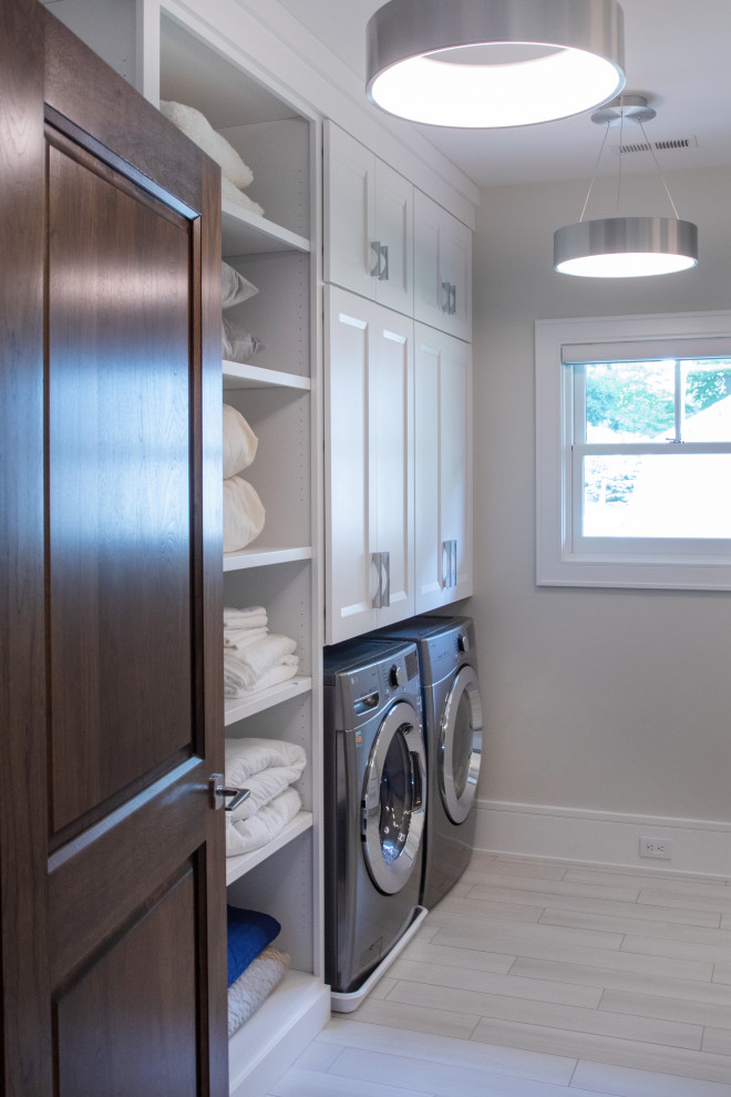 Small elegant galley beige floor dedicated laundry room photo in Milwaukee with recessed-panel cabinets, quartz countertops, a side-by-side washer/dryer and white cabinets