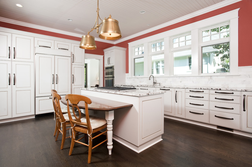 Traditional kitchen in Seattle with recessed-panel cabinets, white cabinets and panelled appliances.