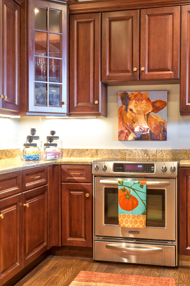 Inspiration for a mid-sized rustic l-shaped medium tone wood floor open concept kitchen remodel in Charlotte with raised-panel cabinets, dark wood cabinets, stainless steel appliances and an island