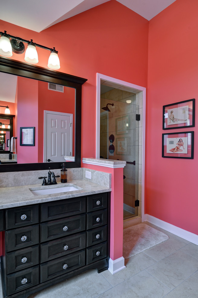 Photo of a mid-sized contemporary kids bathroom in Atlanta with furniture-like cabinets, black cabinets, an alcove shower, beige tile, pink walls and an undermount sink.