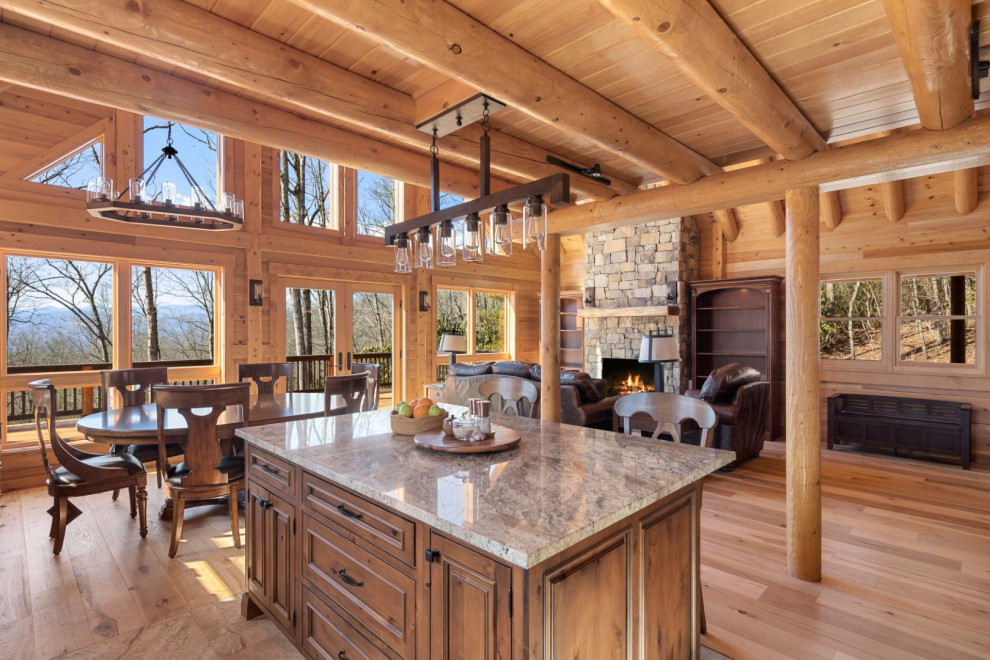 Inspiration for a medium sized rustic open plan dining room in Other with light hardwood flooring, a standard fireplace, a stacked stone fireplace surround and a wood ceiling.