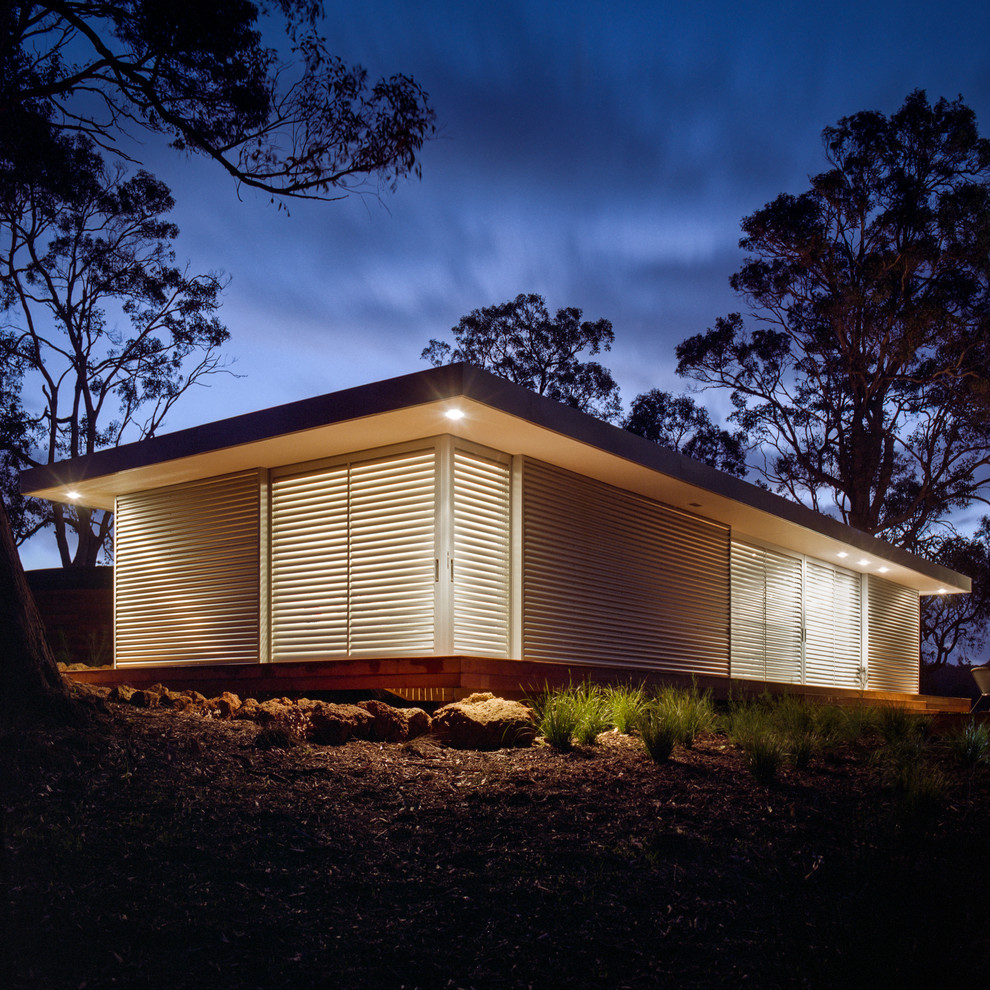 Inspiration for a small contemporary one-storey exterior in Perth with metal siding and a flat roof.