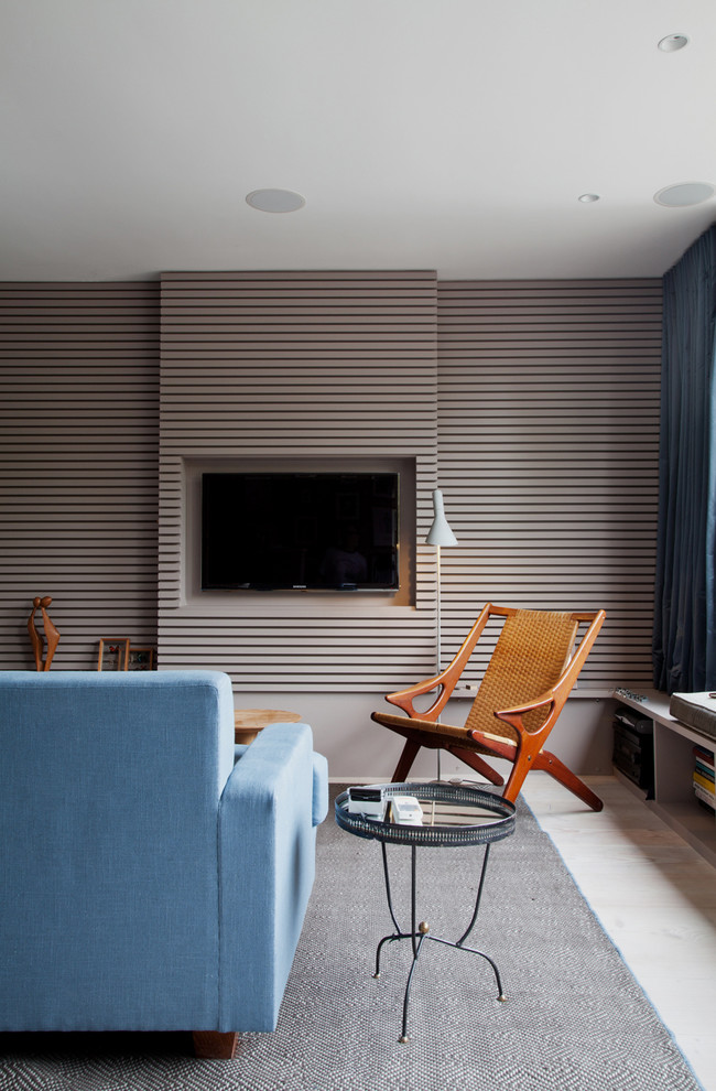 This is an example of a modern living room in London with a wall-mounted tv.