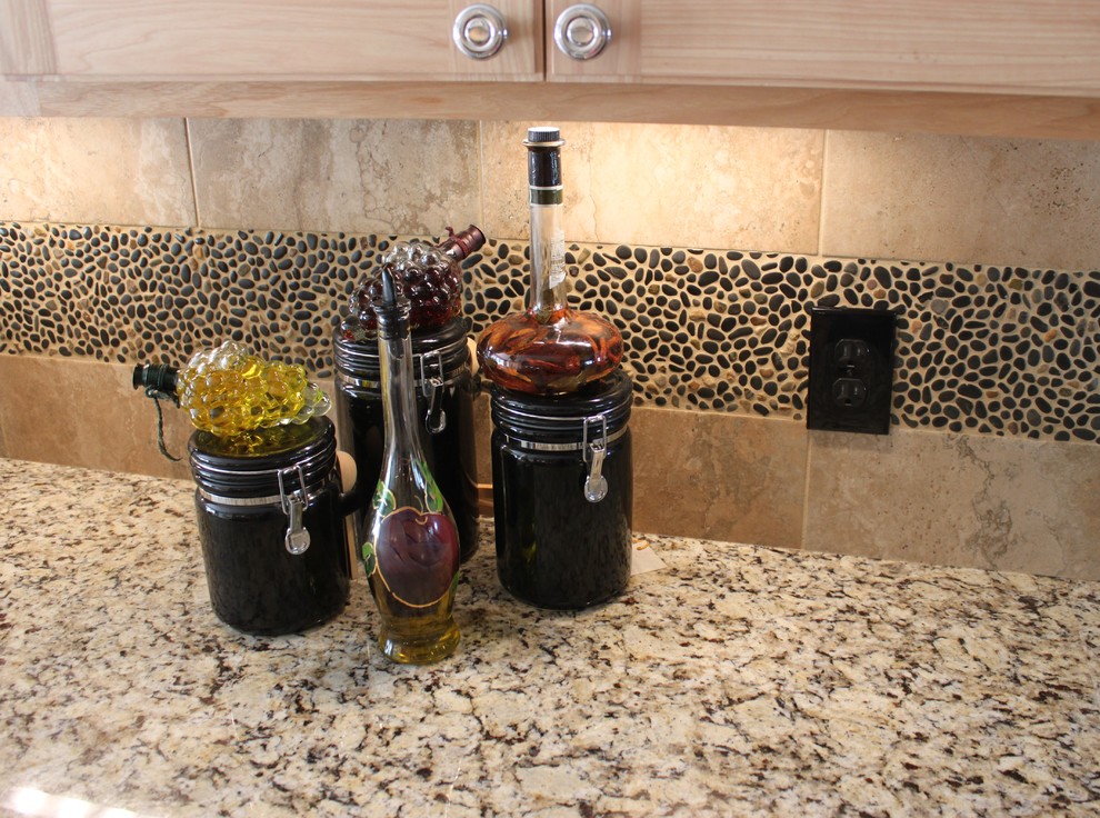 Example of a large transitional galley porcelain tile kitchen design with a double-bowl sink, recessed-panel cabinets, light wood cabinets, granite countertops, brown backsplash, porcelain backsplash and an island