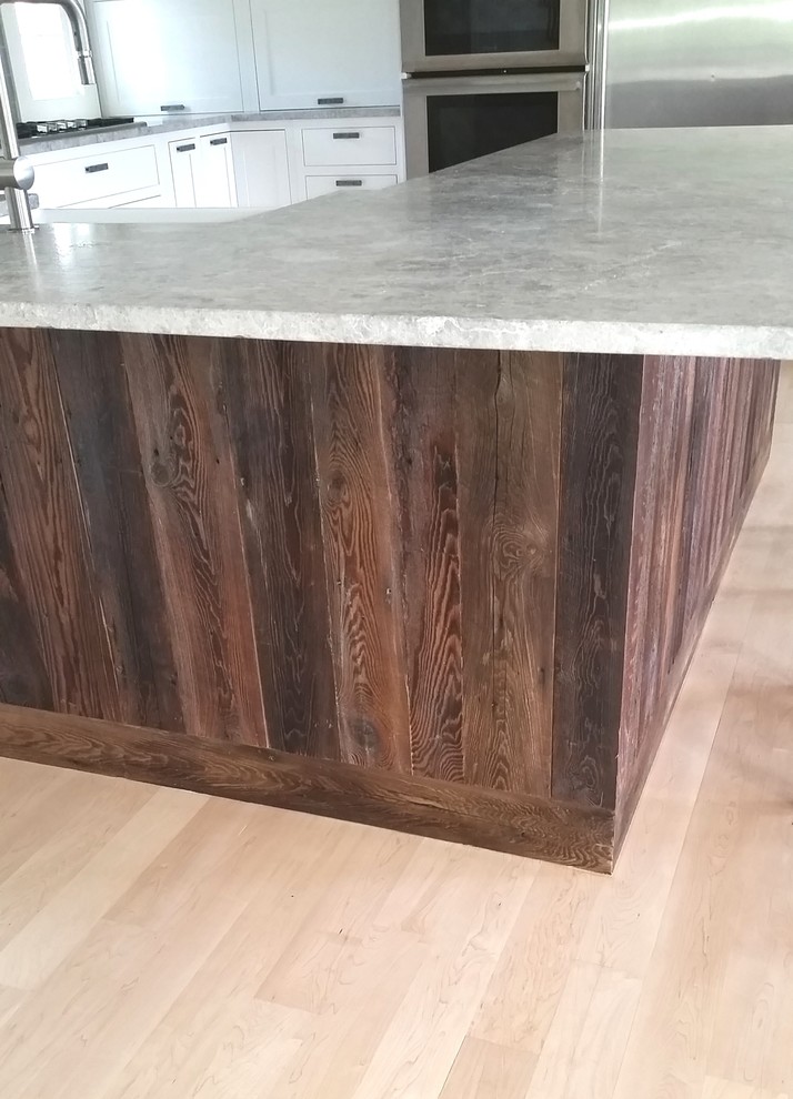Large transitional u-shaped light wood floor eat-in kitchen photo in Boston with a farmhouse sink, shaker cabinets, white cabinets, granite countertops, gray backsplash, porcelain backsplash, stainless steel appliances and an island