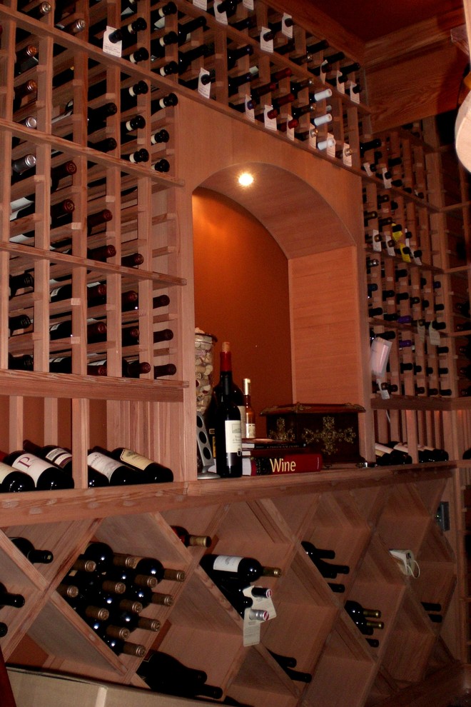 This is an example of a small transitional wine cellar in Orange County with storage racks.