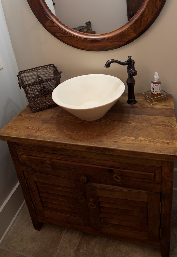 Bathroom - mid-sized rustic 3/4 beige tile porcelain tile bathroom idea with furniture-like cabinets, medium tone wood cabinets and wood countertops