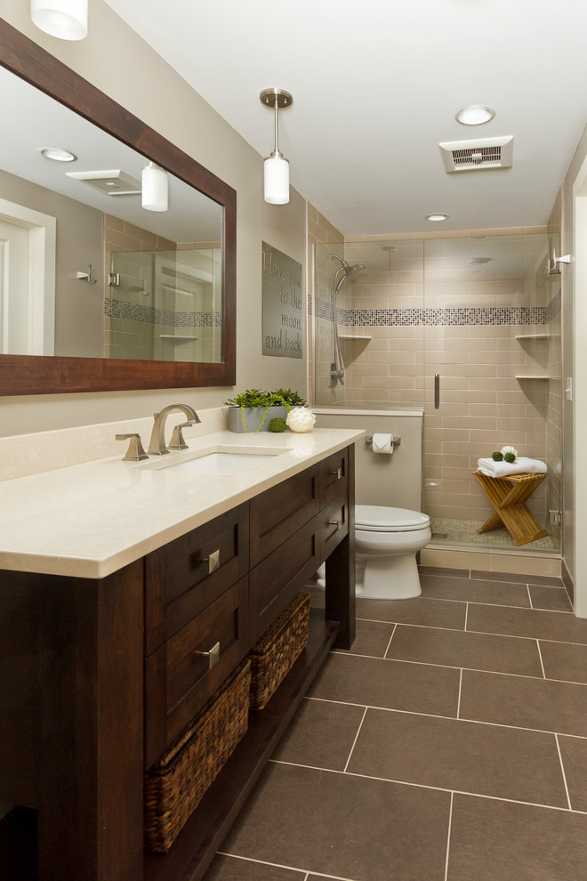 Design ideas for a large contemporary master bathroom in Minneapolis with an undermount sink, shaker cabinets, dark wood cabinets, marble benchtops, an alcove shower, a two-piece toilet, brown tile, subway tile, beige walls and ceramic floors.