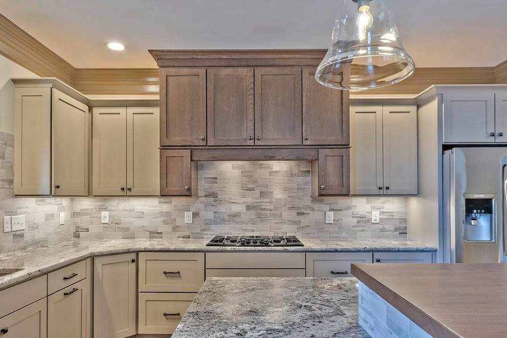 Kitchen - mid-sized l-shaped kitchen idea with medium tone wood cabinets, granite countertops and an island