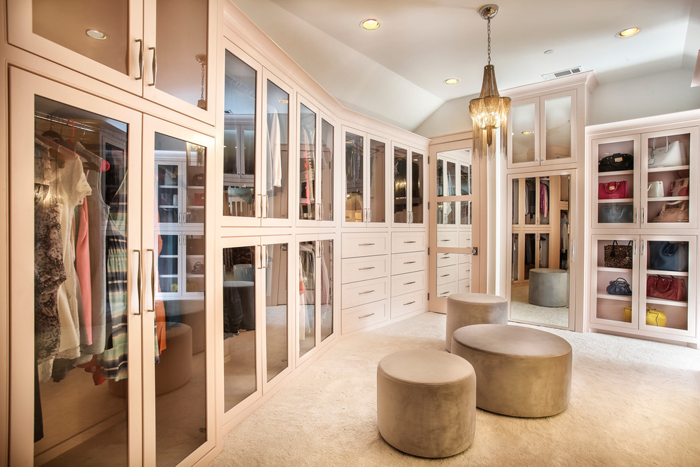 Inspiration for a large transitional master and women's carpeted and beige floor dressing room remodel in Dallas with gray walls, glass-front cabinets and beige cabinets