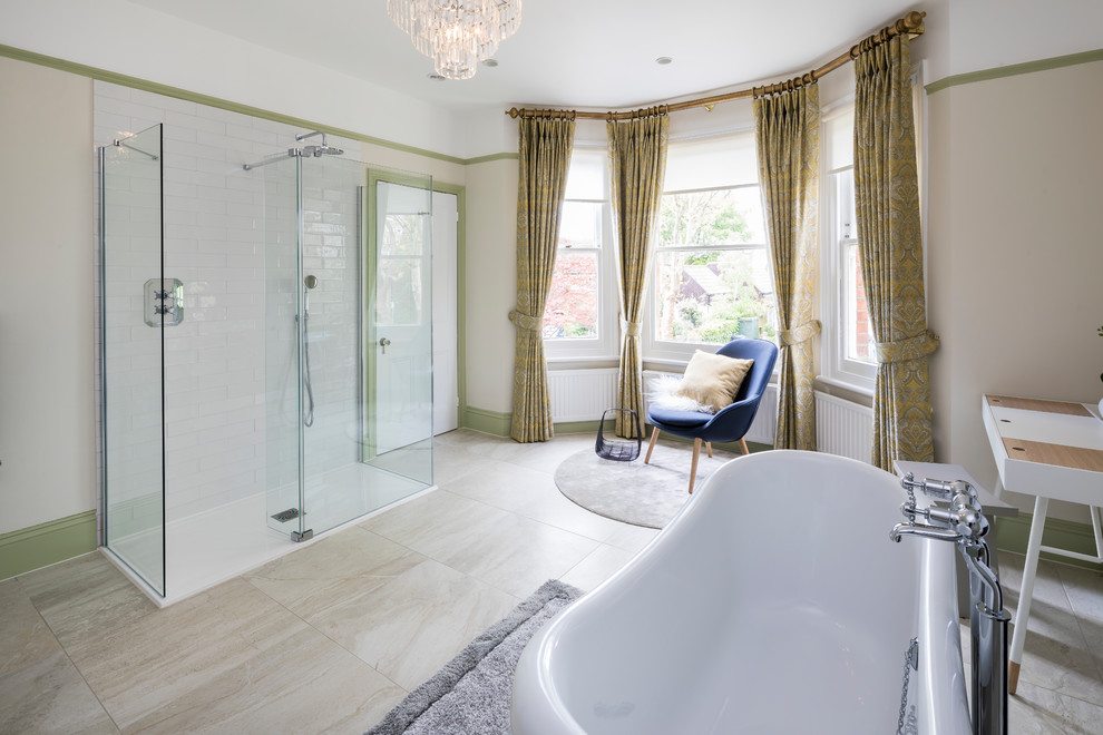 This is an example of a large transitional master bathroom in Surrey with white cabinets, a freestanding tub, an open shower, a wall-mount toilet, white tile, ceramic tile, green walls, ceramic floors, wood benchtops, beige floor, an open shower and white benchtops.